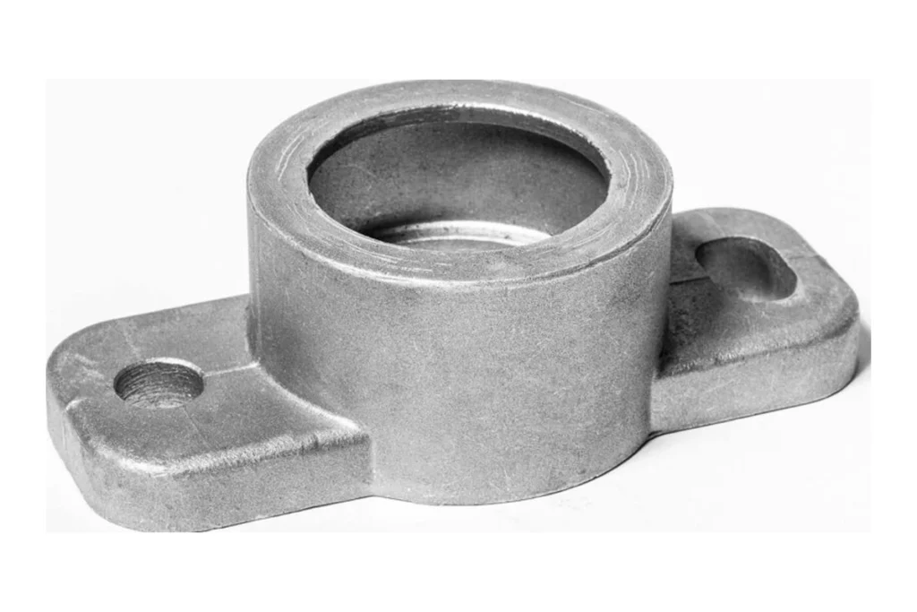 Finished cast metal component with machined mounting holes and cylindrical opening
